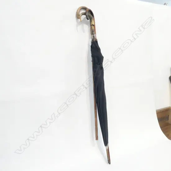 TWO WALKING STICKS AND AN UMBRELLA