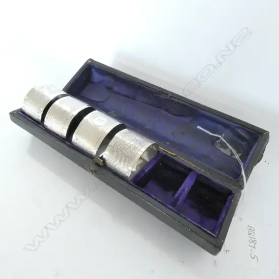 FOUR VICTORIAN SILVER NAPKIN RINGS IN BOX (2 absent)