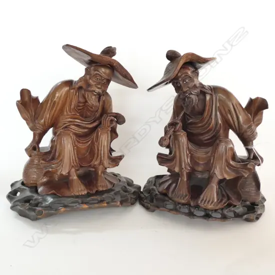 A PAIR OF WELL CARVED HARDWOOD CHINESE ELDERLY MEN ON STANDS H 290 MM
