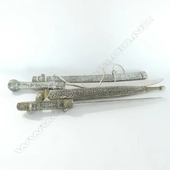 TWO MIDDLE EASTERN SHORT SWORDS WITH DECORATIVE METAL SCABBARDS (ww)