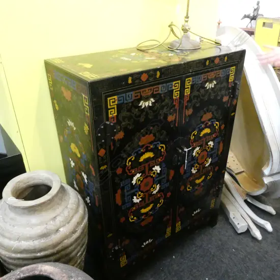 A TIBETIAN CUPBOARD WITH ALL OVER DECORATION SOME WARE H 1100 MM