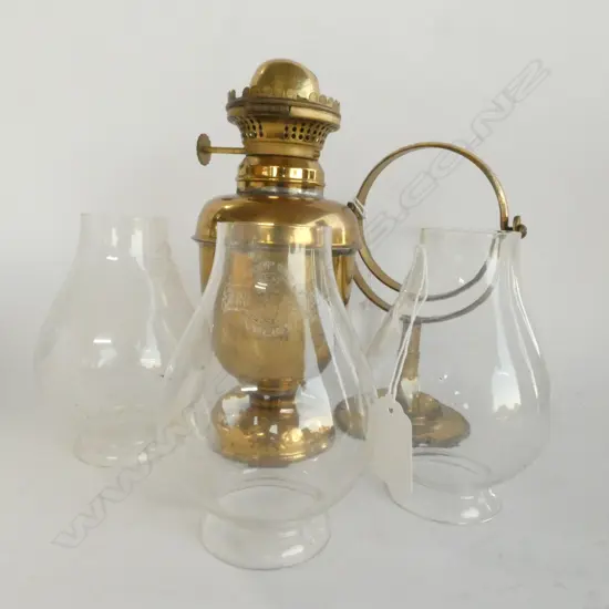 A BRASS GIMBALED LAMP WITH 3 GLASS CHIMNEYS H 320 MM