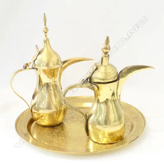 TWO ARAB BRASS TEAPOTS, TEASPOON AND TRAY 380MM DIA