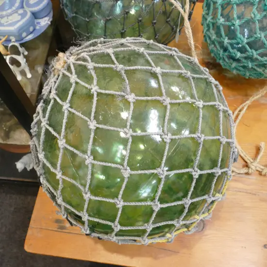 OLD LARGE GLASS FISHING FLOAT WITH NETTING