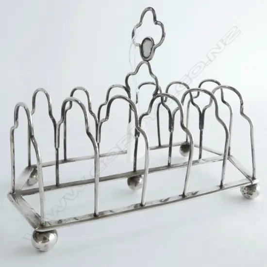 SIX SLICE STG SILVER TOAST RACK, TESTED, ODD HALLMARKS, NO DATE MARK. SPLIT TO BASE CORNER, 180GMS