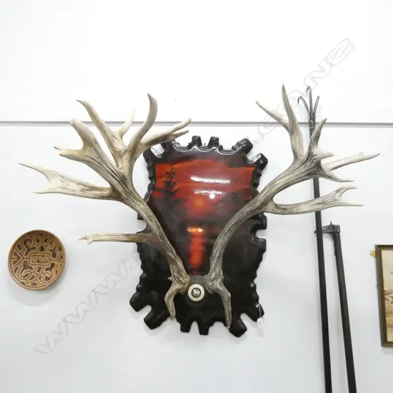 8 POINT ANTLERS ATTACHED TO ROUND PLAQUE 'WHITE HORSE WHISKY' MOUNTED ON SCENIC INLAY WOOD BACKGROUND 