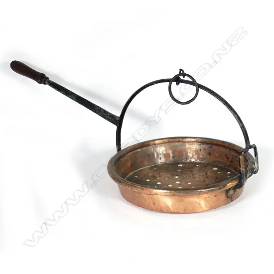 A Victorian street vendor's copper chestnut roasting pan