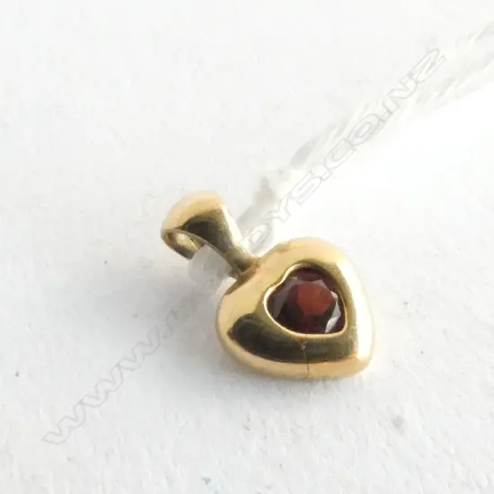 TINY RED STONE PENDANT (PROB GARNET) SET IN 9ct GOLD