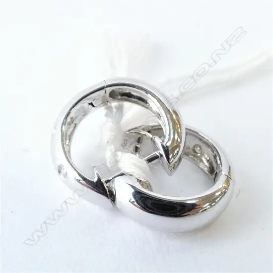 A pair of 9ct white gold and diamond earrings