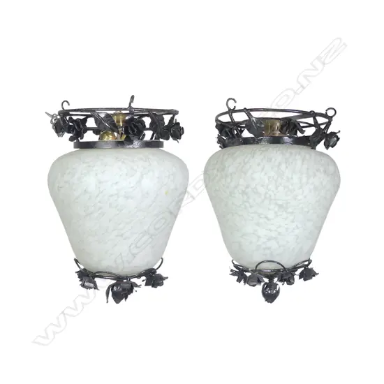 A pair of glass and wrought iron light shades