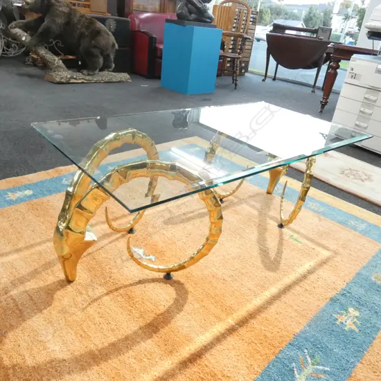 MODERN BRASS AND GLASS COFFEE TABLE - BRASS SUPPORTS IN THE FORM OF ANIMAL HORNS