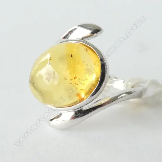 SILVER  MOUNTED AMBER INSECT RING