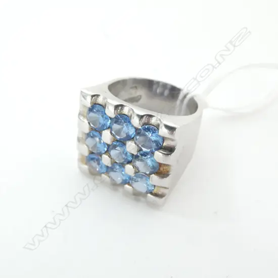 SILVER RING PAVE SET WITH 9 BLUE CZs