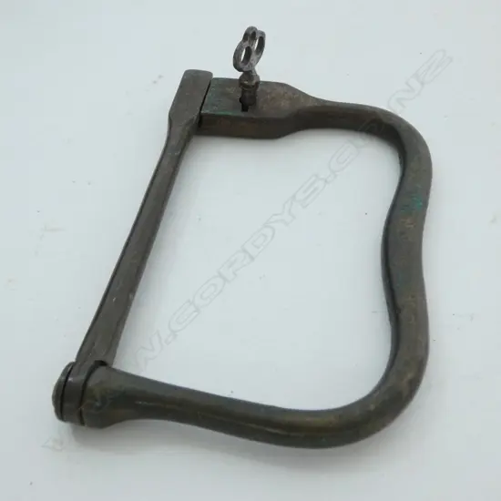 A brass Kit Bag Lock with an internal lock. Kit Bag locks were useful pieces of equipment to the traveler or soldier. They could be used to secure your luggage to railings at a station or on a train