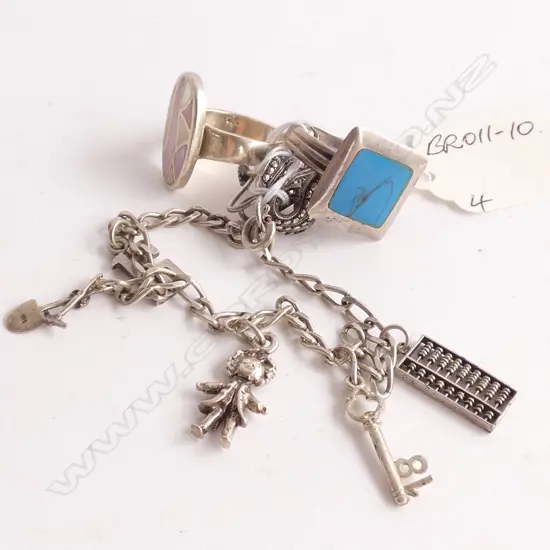 4 SILVER JEWELLERY ITEMS. CHARM BRACELET + 2 RINGS +