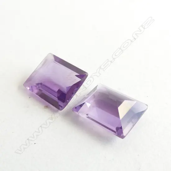 TWO FACETED RECTANGULAR AMETHYST STONES 9.43CT (TOTAL)