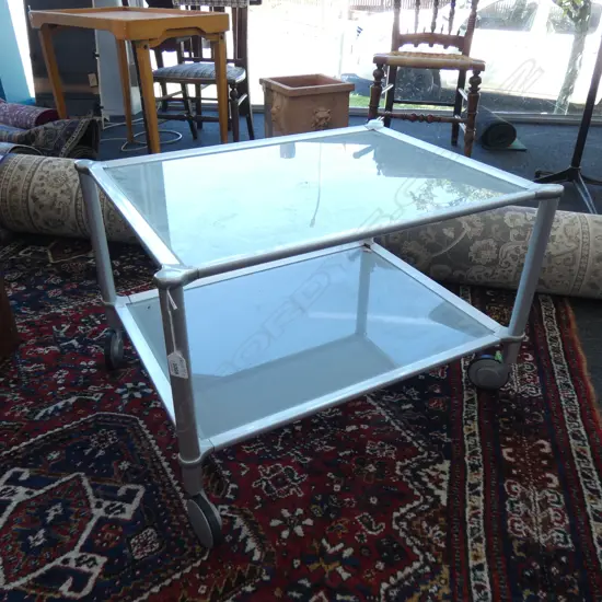 MODERN GLASS COFFEE TABLE ON WHEELS W. 670MM