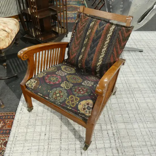 1900 OAK MORRIS STYLE CHAIR ON CASTORS + KELIM CUSHION
