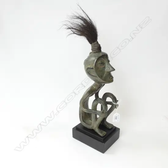 BRONZE SEATED TRIBAL FIGURE ON STAND H.430mm
