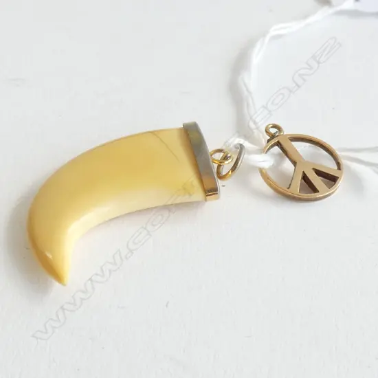 2 PENDANTS; ONE CARVED SCRIMSHAW & ONE 9CT GOLD PEACE SIGN