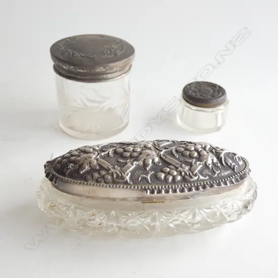 3 GLASS & STG SILVER LIDDED DRESSING TABLE JARS; 2 ROUND / 1 OVAL L. 125MM