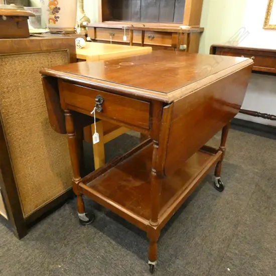DROP SIDE MAHOGANY TEA TROLLEY...