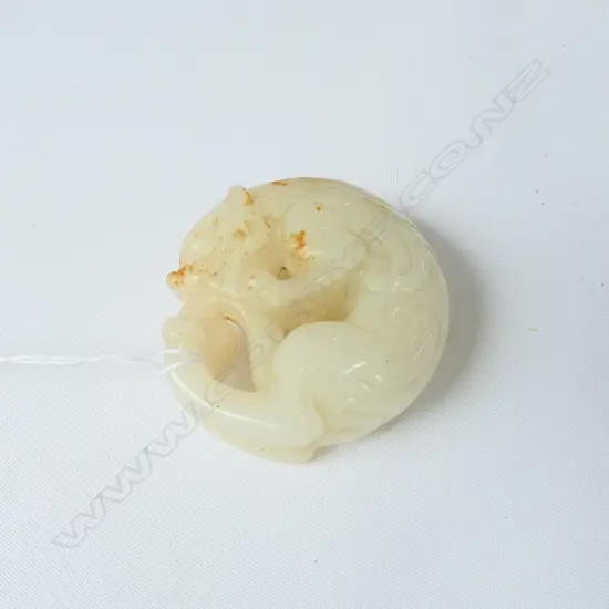 CHINESE WHITE JADE CIRCULAR HANDLING PIECE WITH RUSSET SURFACE INCLUSIONS OF A MYTHICAL ANIMAL . DIA.52mm
