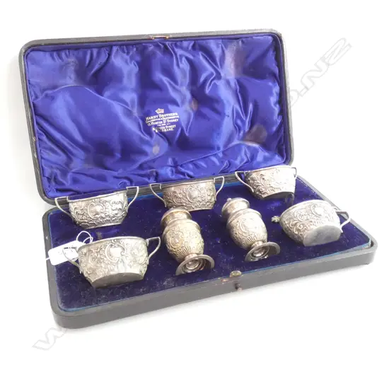 A late Victorian seven-piece cased silver horse-racing club prize condiment set