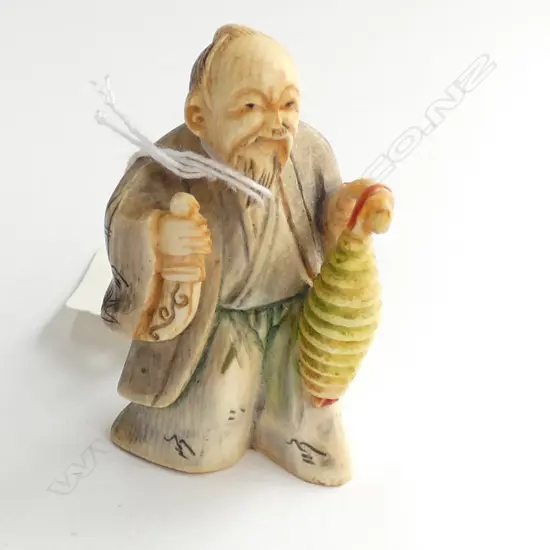 JAPANESE CARVED IVORY NETSUKE MAN WITH....