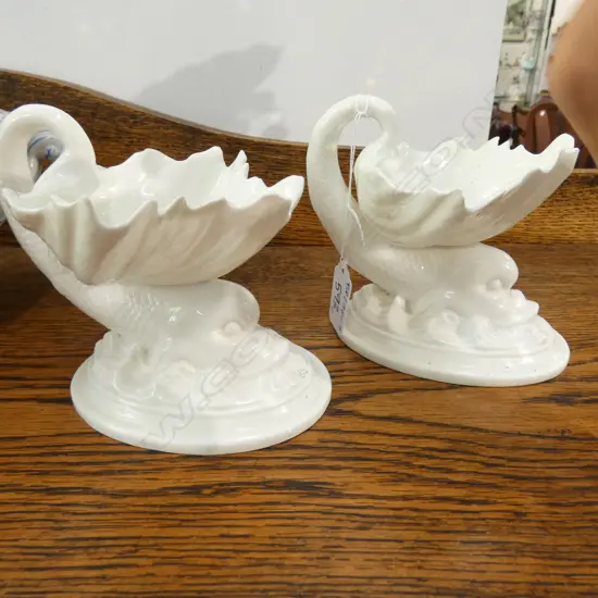 A PAIR OF ROYAL WORCESTER DOLPHIN TABLE SALTS