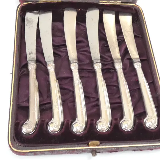 A cased set of six Victorian silver pistol grip handled butter knives