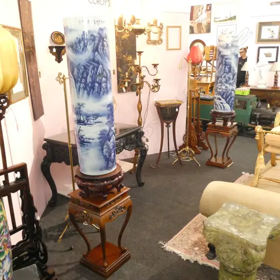 2 MASSIVE CHINESE PORCELAIN CYLINDRICAL VASES, DECORATED WITH LANDSCAPES IN BLUE & WHITE, WITH STANDS