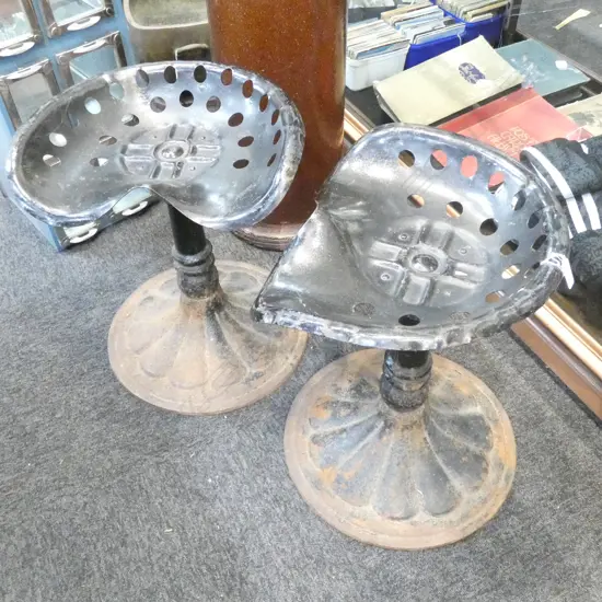A PR OF VINTAGE TRACTOR SEAT STOOLS