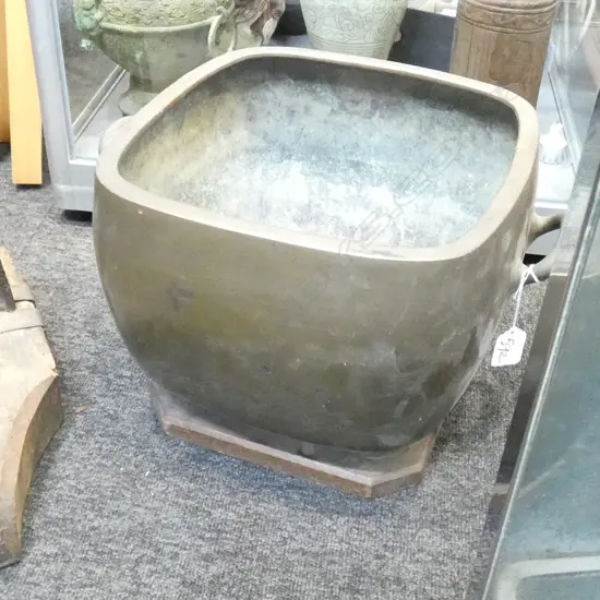 LARGE OLD BRASS JAPANESE HANDLED POT ON WOODEN BASE H. 255MM