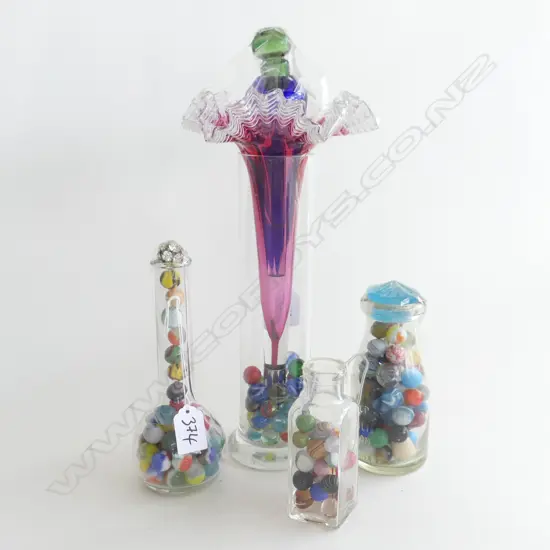 (53) 4 GLASS BOTTLES OF MARBLES