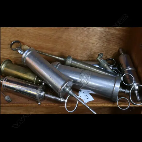 7 VARIOUS SYRINGES, (BRASS, NICKEL & CHROME) LGE BRASS ONE LABELLED 'MAYER MELTZER MAKERS LONDON' w WARRENT COAT-OF ARMS