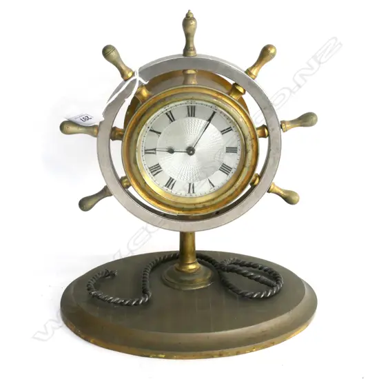 BRASS & SILVER PLATE SHIP'S WHEEL DESK CLOCK. MARKED: R&Co PARIS. SILVERED GUILLOCHE DIAL. (2 SPOKES ABSENT) H.280mm