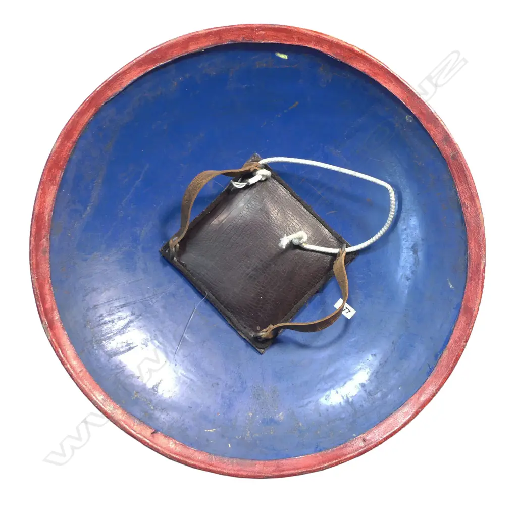 Two Tulwar Swords and matching Dahl Shield from the Punjab Region, India. A matching pair of 28" deeply-curved wootz blades with a gold cartouche to each; double-edged tips and serrated notch-backed to 3/4 of their lengths. The hilts are profusely gold damascened (one with a pommel spike, the other a dome). Matched leather scabbards with raised gilding on a red ground. Along with a matching Dahl shield, dia.20". Believed to have been made as a presentation set. Image 1++