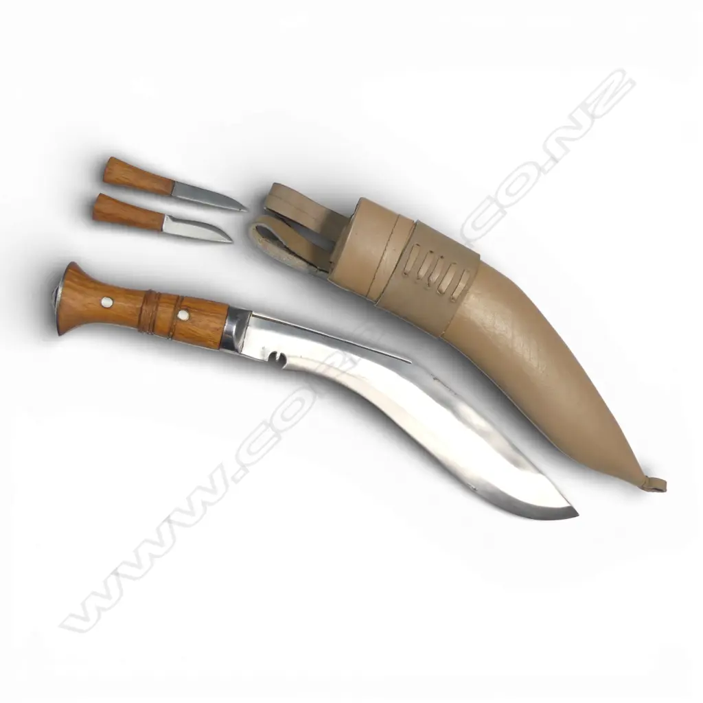Contemporary Nepalese Khukri Knife, with heavy 11" blade, handle of Indian rose wood as are the handles on the small knives. Cream coloured leather scabbard with twin belt loops. Image 1++