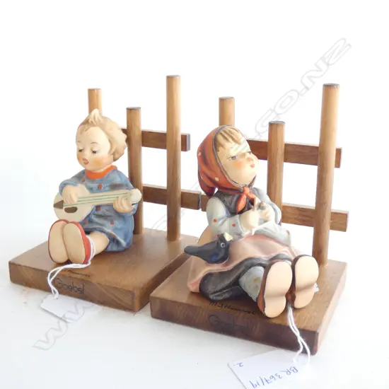 2 HUMMEL FIGURINES ON WOODEN DISPLAYS; #53 'JOYFUL' GIRL w. GUITAR & #69 'HAPPY PASTIME' GIRL KNITTING w. BIRDS' H.125m 