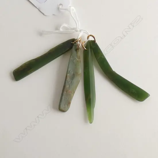 FOUR POUNAMU PENDANTS WITH 18CT GOLD RINGS