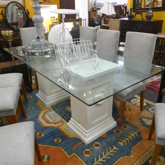 GLASS TABLE TWO OAMARU STONE PLINTH BASES...