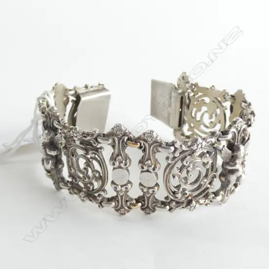 WIDE SILVER (?)  BRACELET WITH CHERUBS