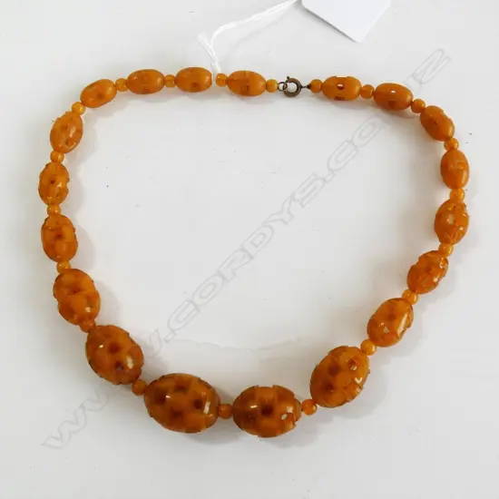AMBER/PLASTIC ? CARVED BEAD NECKLACE