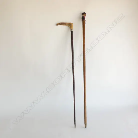 2 WALKING STICKS; 1 CARVED WOODEN HANDLE & 1 DEER ANTLER HANDLE w LEATHER CANE