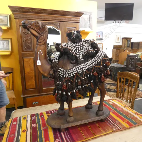 LARGE CARVED WOODEN CAMEL, 700mm x 850mm x 180mm AND CAMEL HEAD DRESS, MADE OF CAMEL HAIR