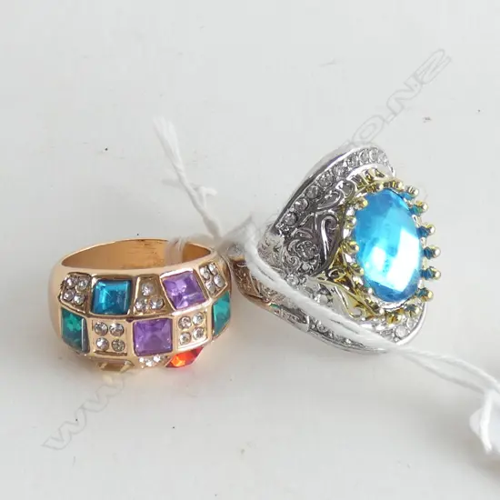 2 RINGS. 1X SILVER & BLUE ZIRCON. 1X GILT MULTI GEM