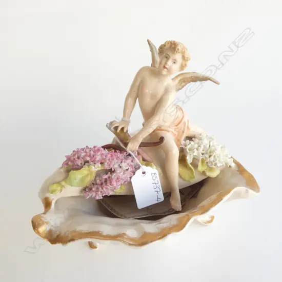 PLAUE, THURINGIA (GERMANY) GILDED PORCELAIN SHELL WITH FLOWERS & CHERUB. H.190mm MARKS TO BASE. WING CHIPPED