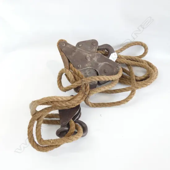 OLD HEAVY METAL PULLEY WITH ROPE
