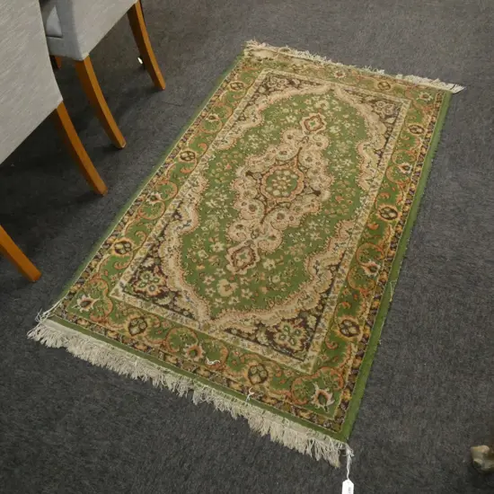 GREEN WOOL PILE RUG ONE CORNER A/F1450x890mm